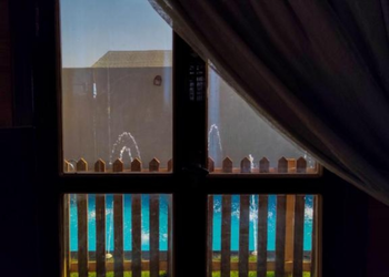 كوخ بمسبح العاب مائية ومسطح اخضر