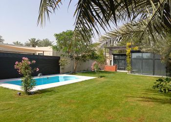 استراحة بمسبح خارجي ومسطح اخضر